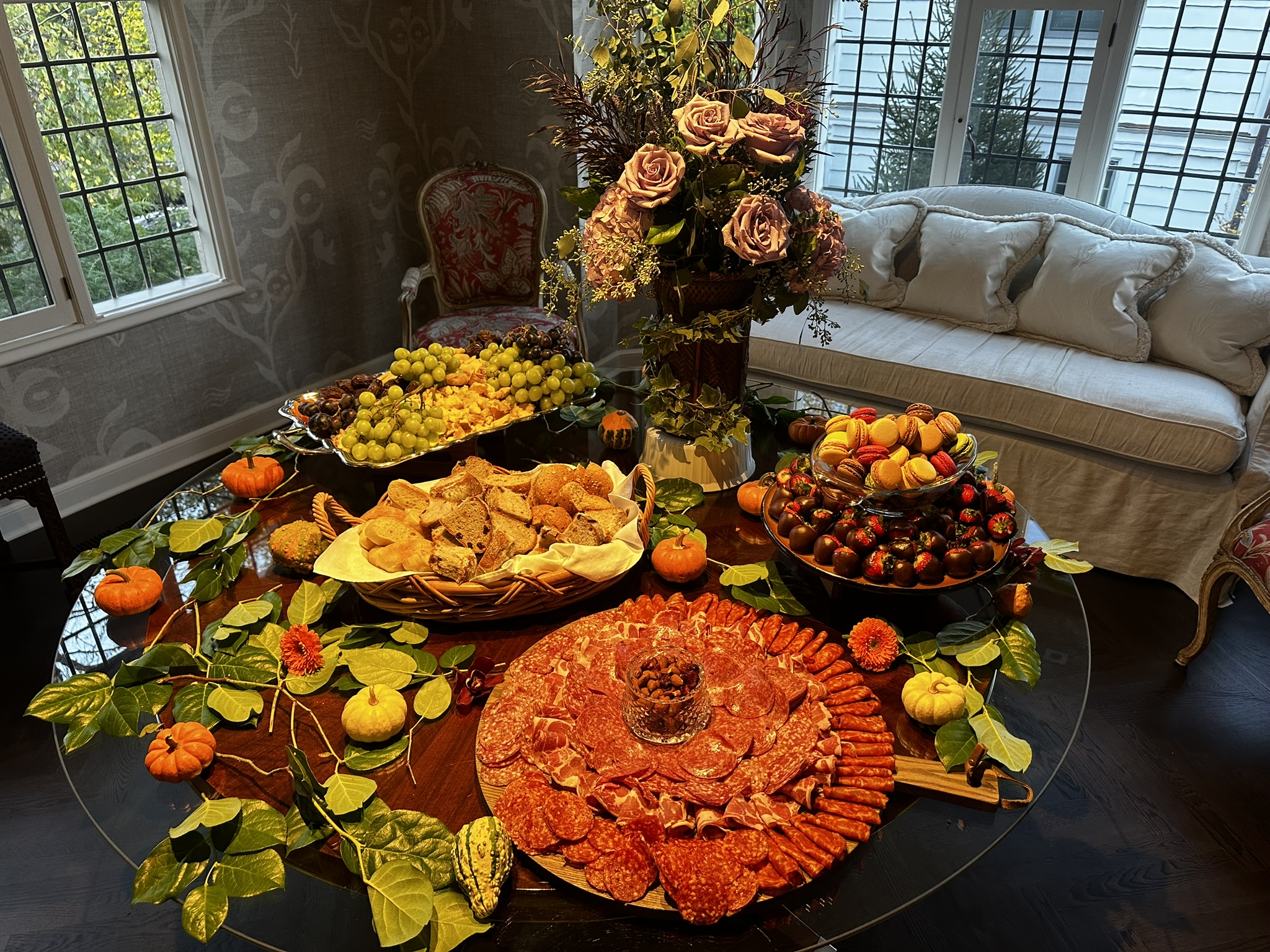 Fall event spread with pumpkins, flowers, and seasonal platters