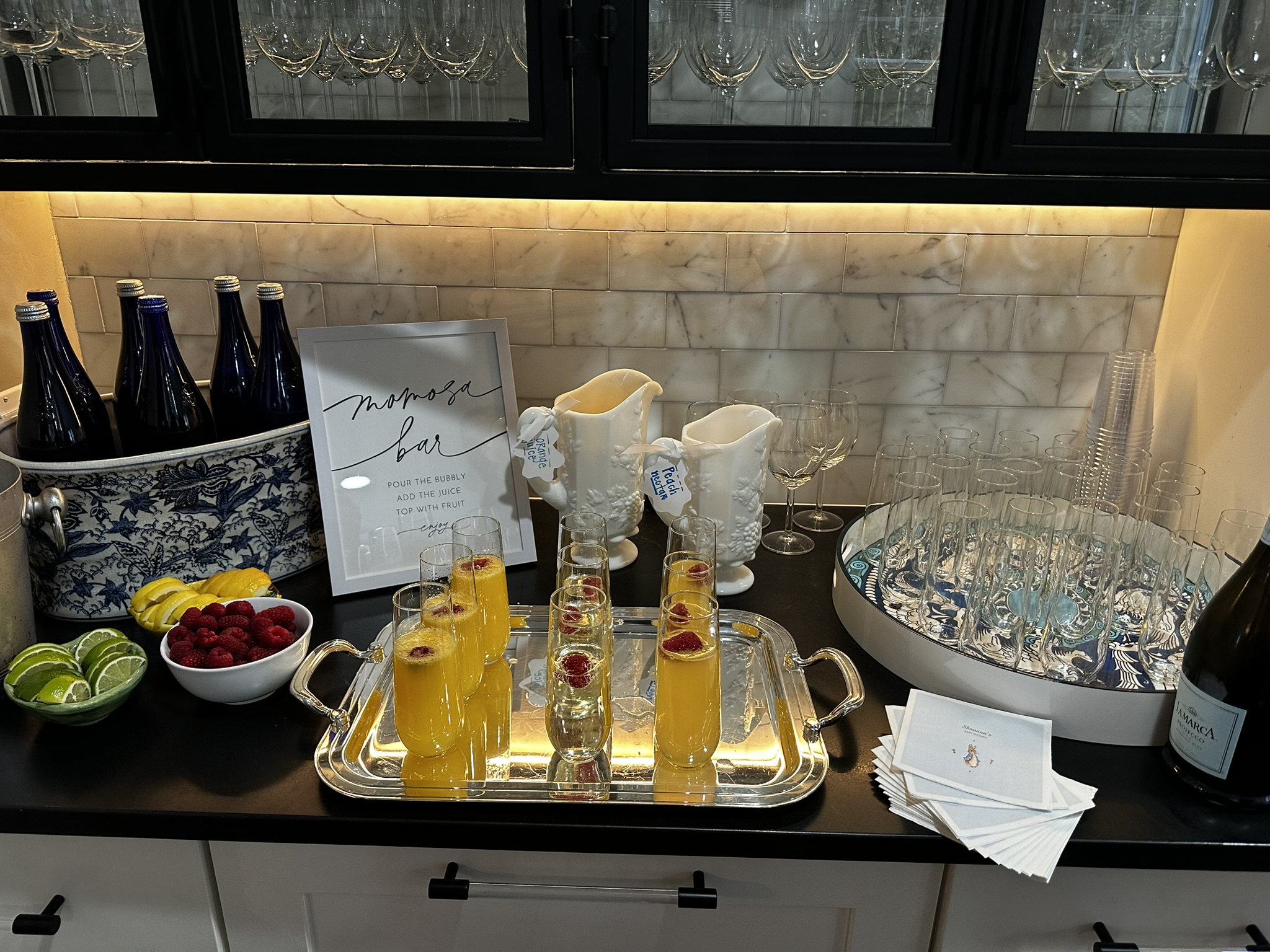 Full bar setup with crystal glasses, bottles, and ice